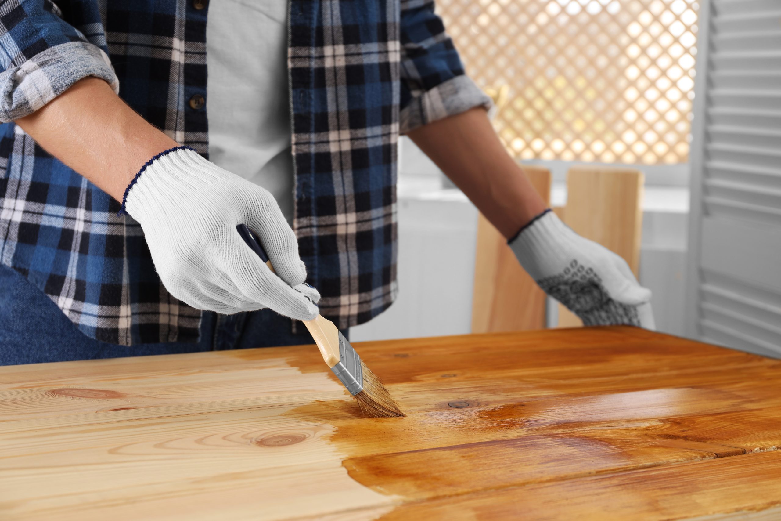 Wood Floor Sanding in West Brompton with finish being applied to a newly sanded solid pine wood floor, highlighting the smooth grain and rich colour.