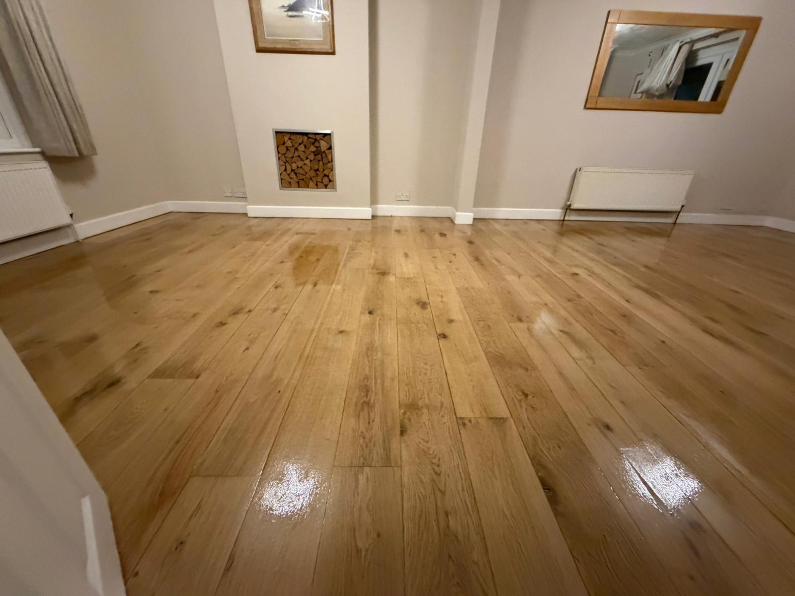 Hardwood Floor Sanding in West Brompton on an oak hardwood plank living room floor, showing a smooth, freshly refinished surface with a warm satin sheen.
